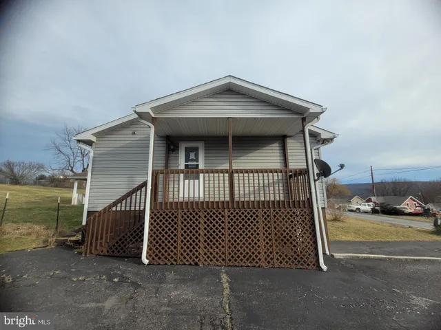 a view of a brick house with a small yard