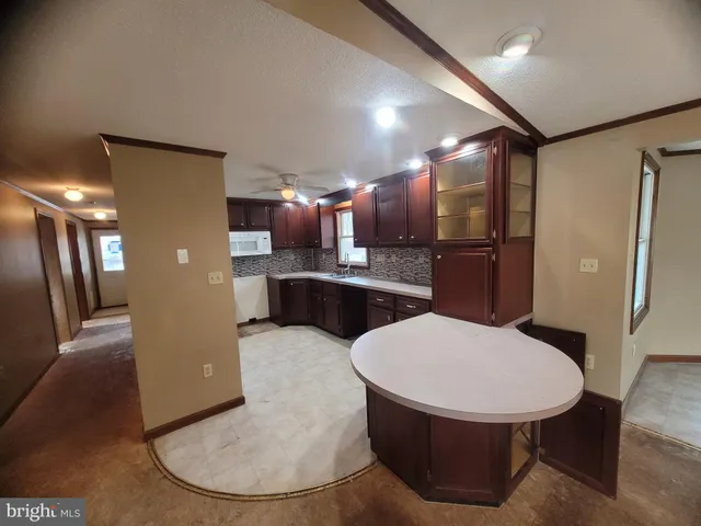 a kitchen with a table and chairs