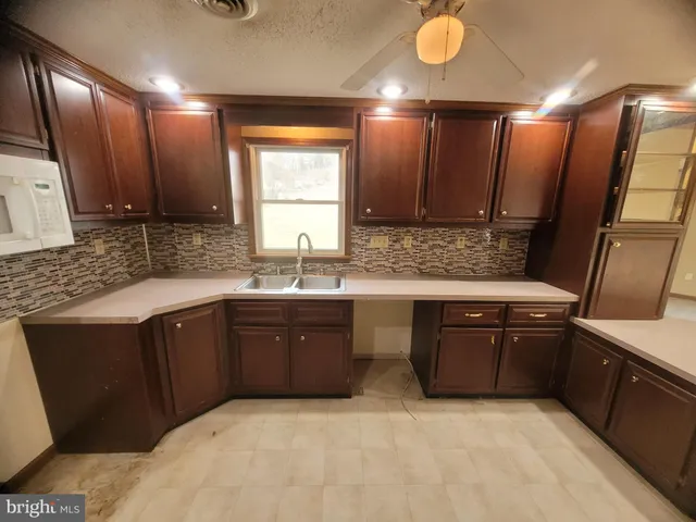a kitchen with a sink stove and cabinets