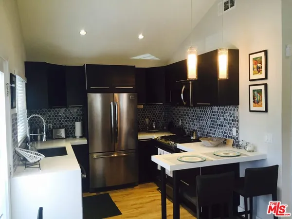 a kitchen with a sink cabinets and refrigerator