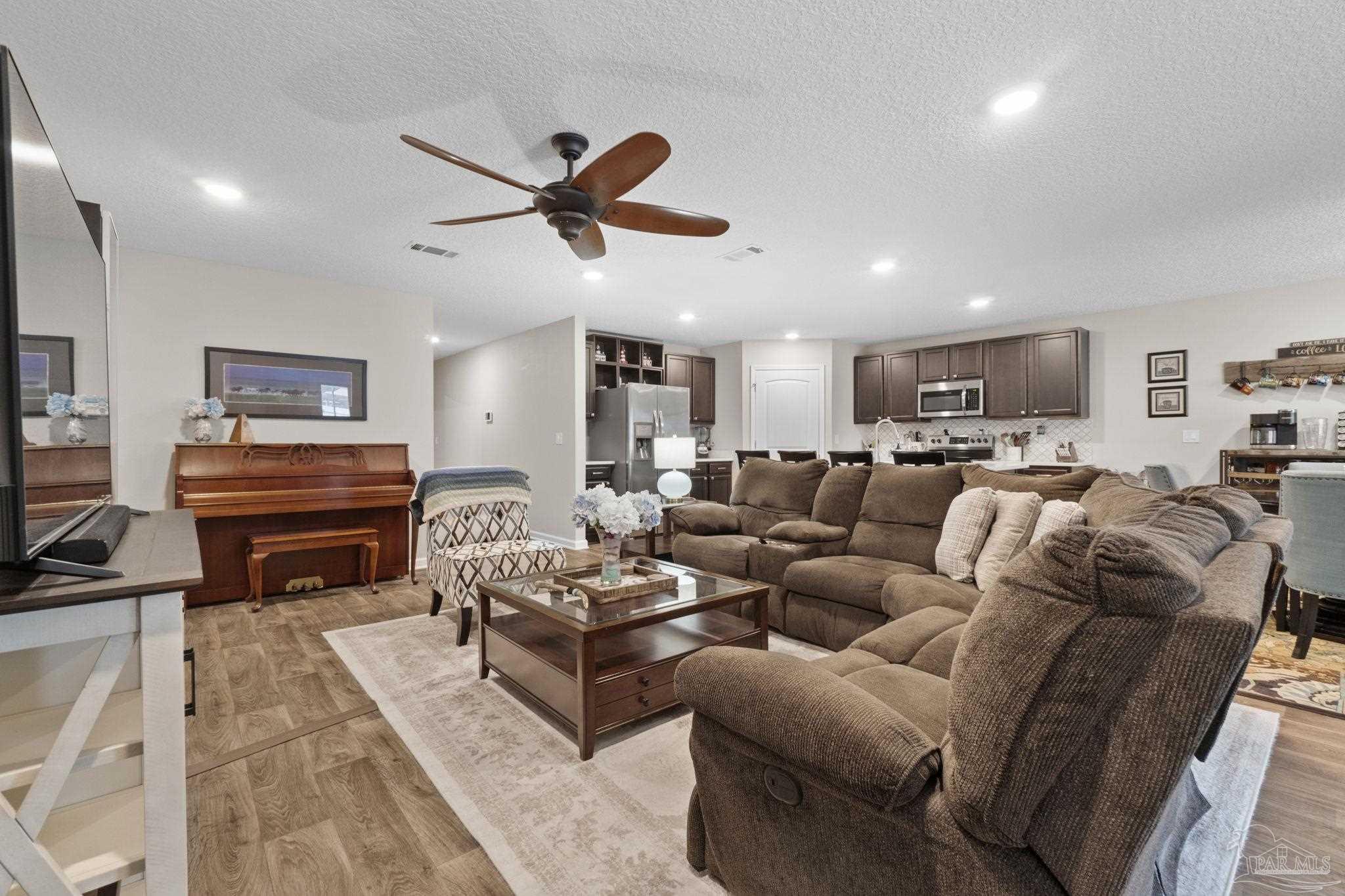4082 Chickadee Street Milton, FL 32583 - Photo 18 of 43 a living room with furniture kitchen view and a window
