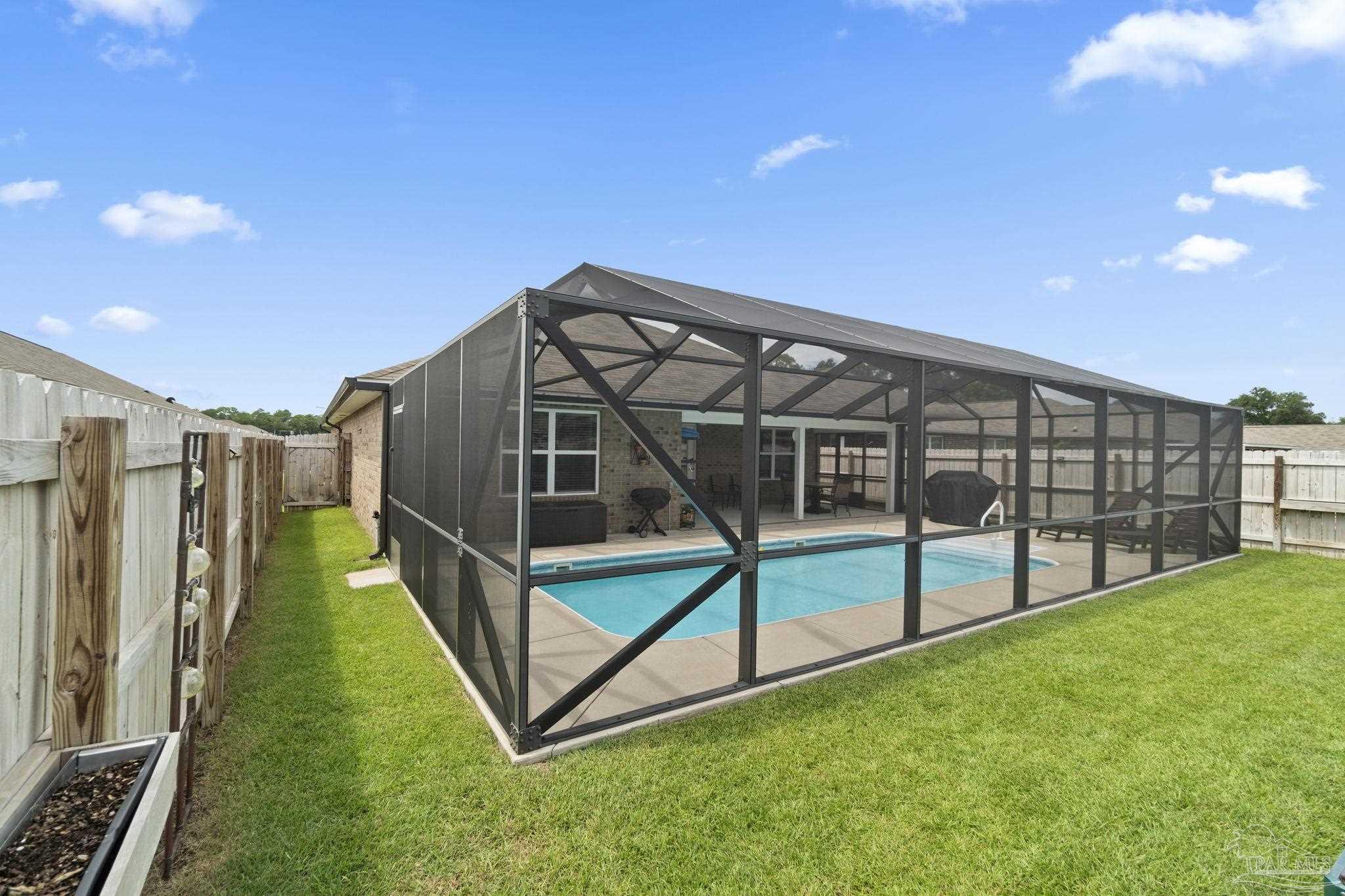 4082 Chickadee Street Milton, FL 32583 - Photo 2 of 43 a view of backyard with deck and a garden