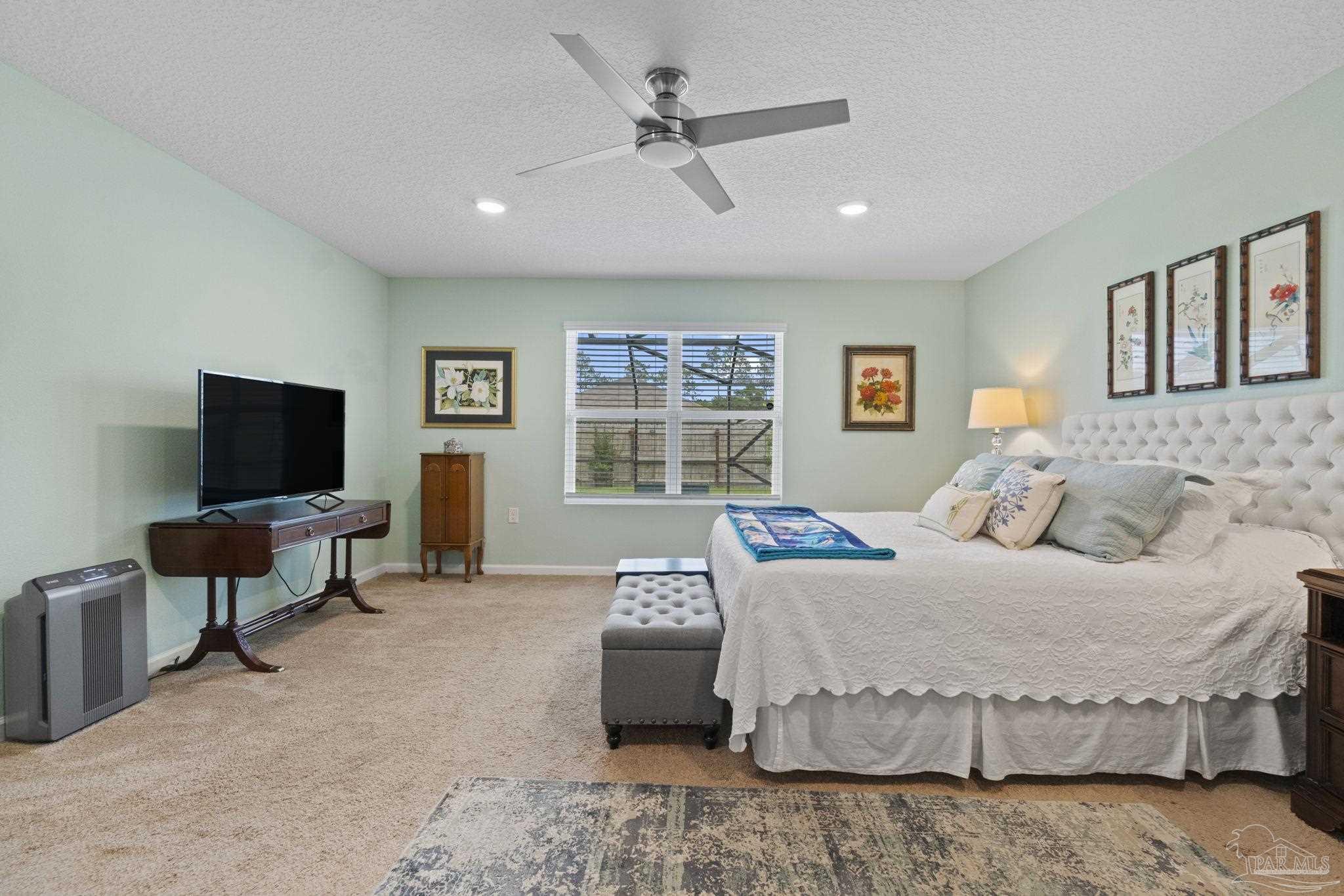 4082 Chickadee Street Milton, FL 32583 - Photo 21 of 43 a bedroom with a bed and a flat screen tv