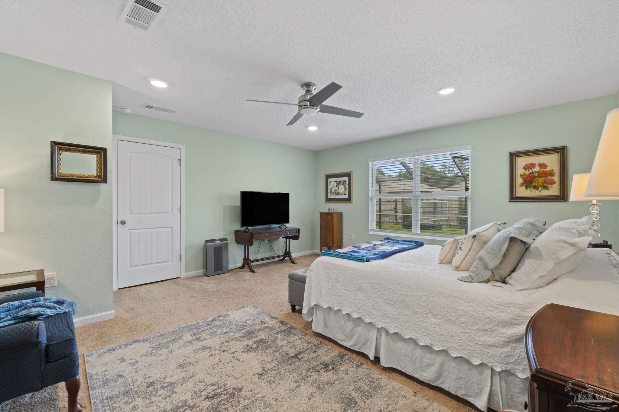 4082 Chickadee Street Milton, FL 32583 - Photo 22 of 43 a bedroom with a bed and a flat screen tv