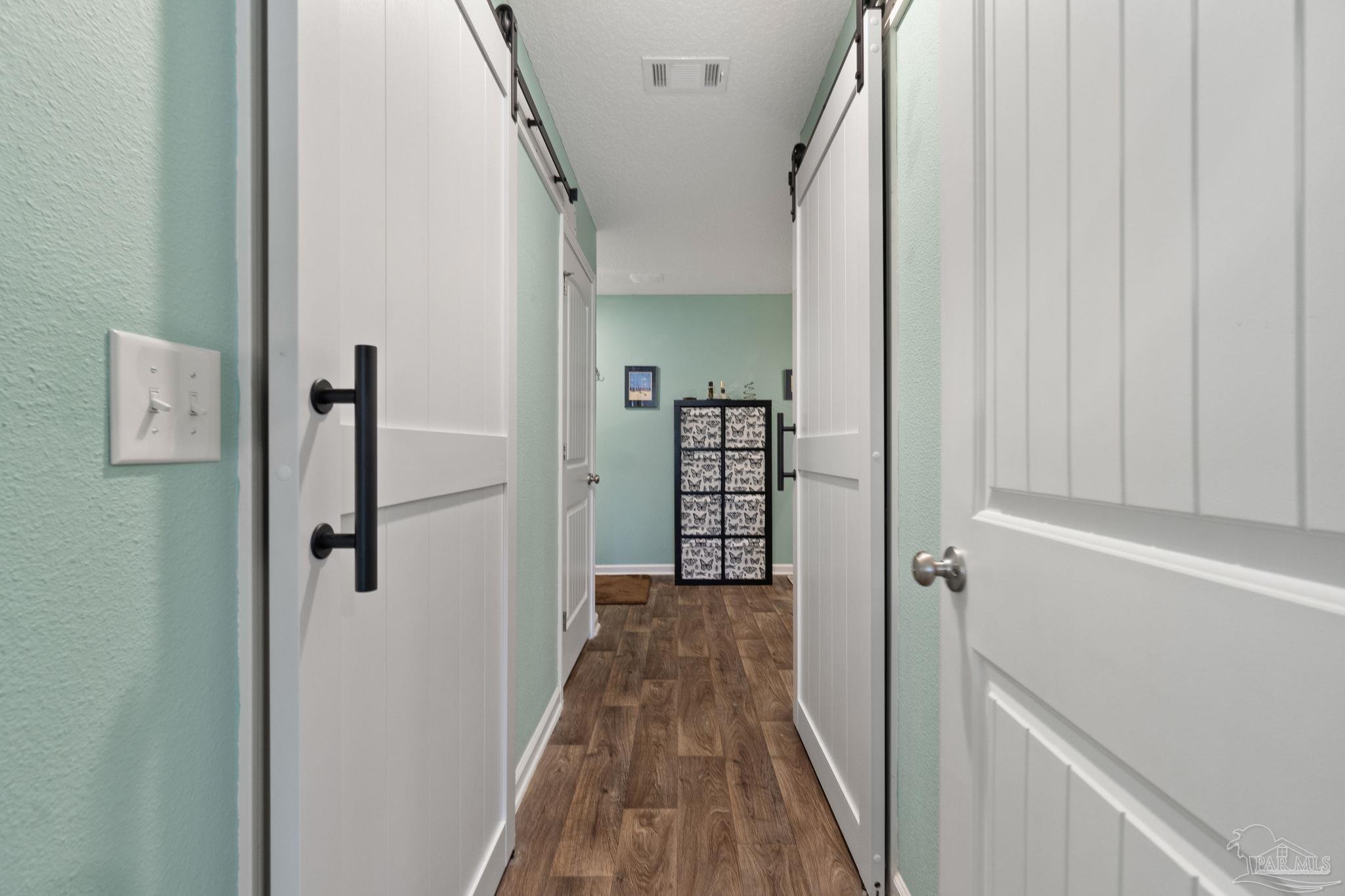 4082 Chickadee Street Milton, FL 32583 - Photo 25 of 43 a view of a hallway with wooden floor and staircase