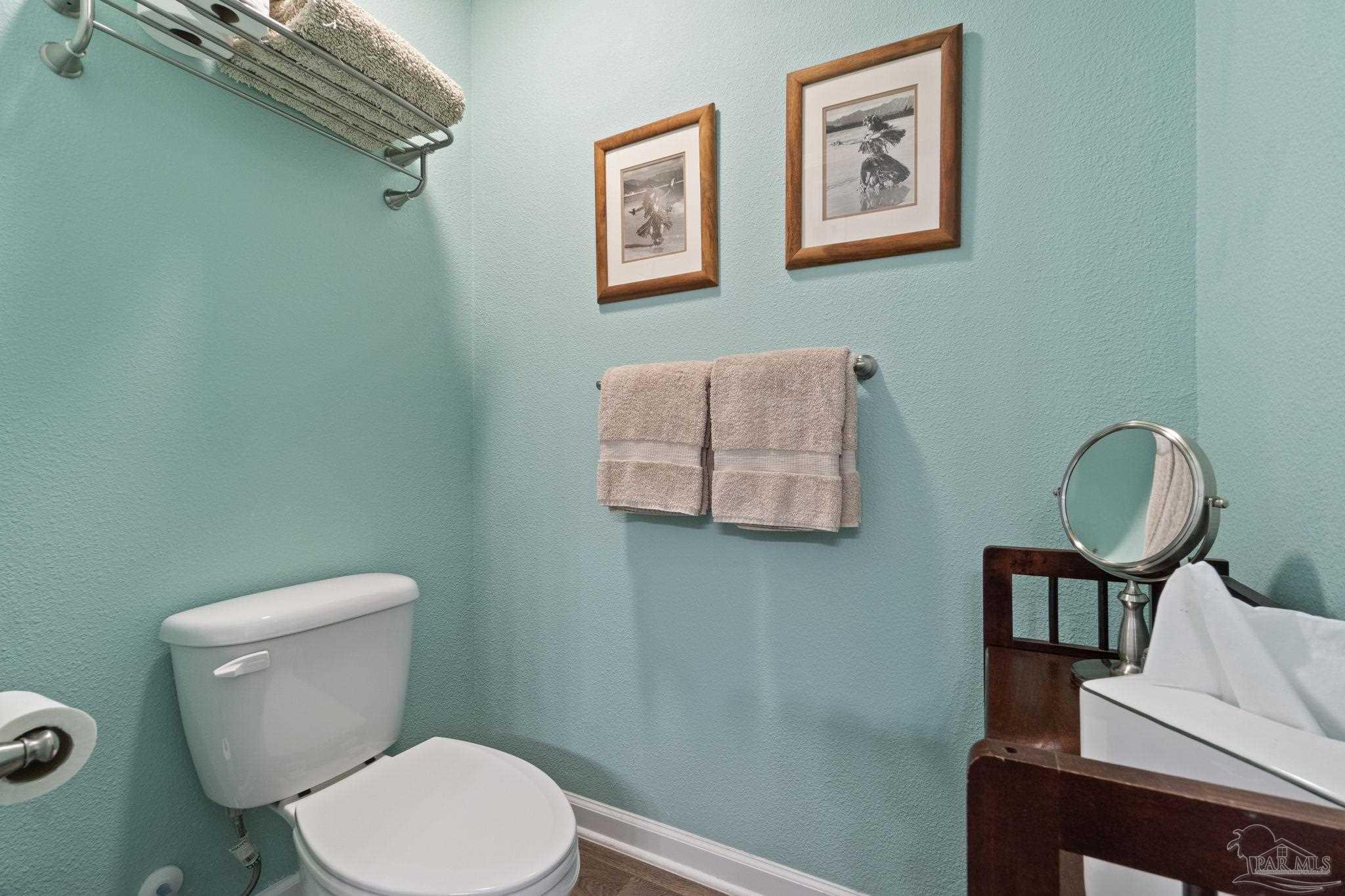 4082 Chickadee Street Milton, FL 32583 - Photo 28 of 43 a white toilet sitting next to a bathroom sink