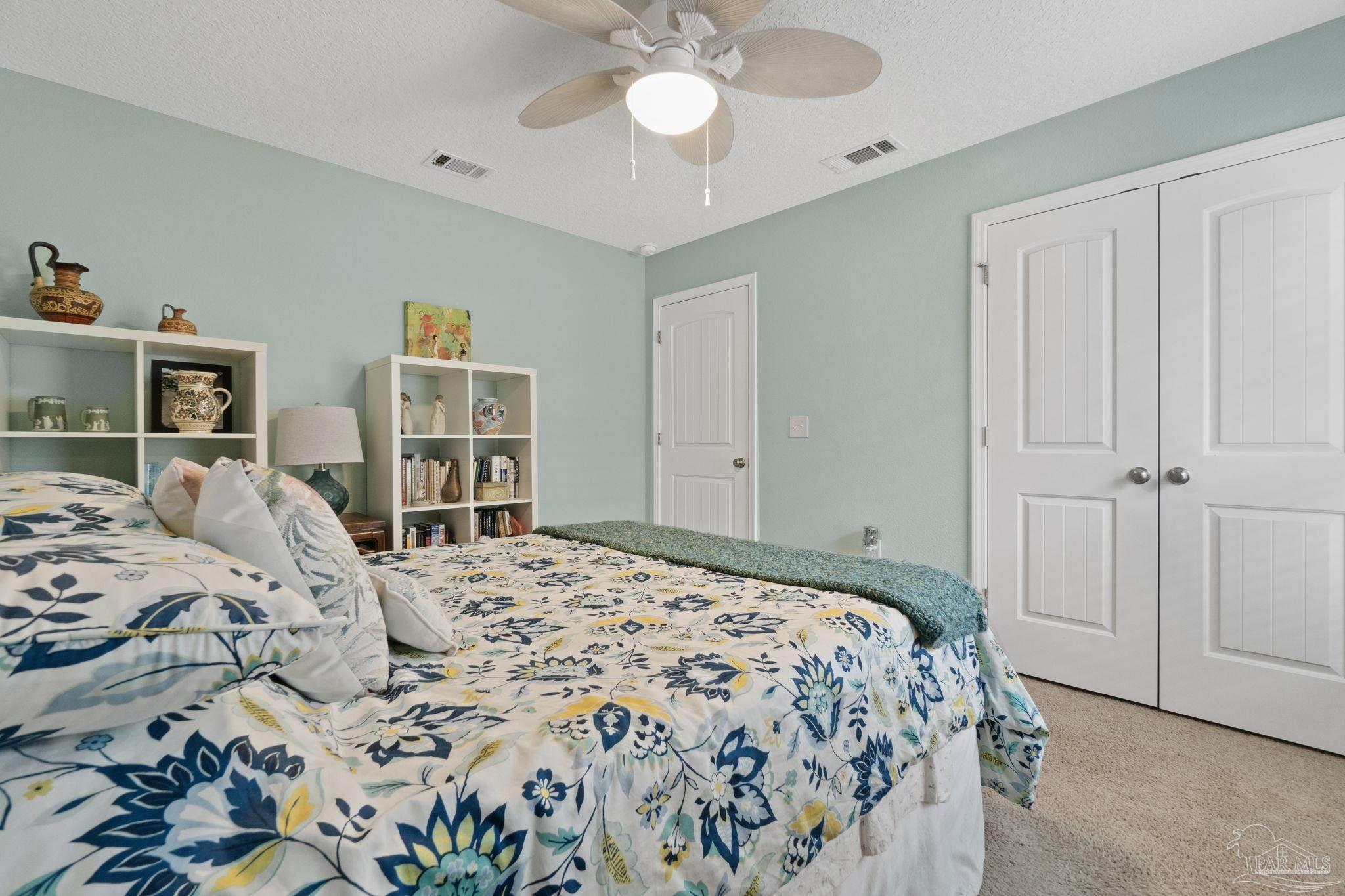 4082 Chickadee Street Milton, FL 32583 - Photo 32 of 43 a bedroom with a bed and a chandelier