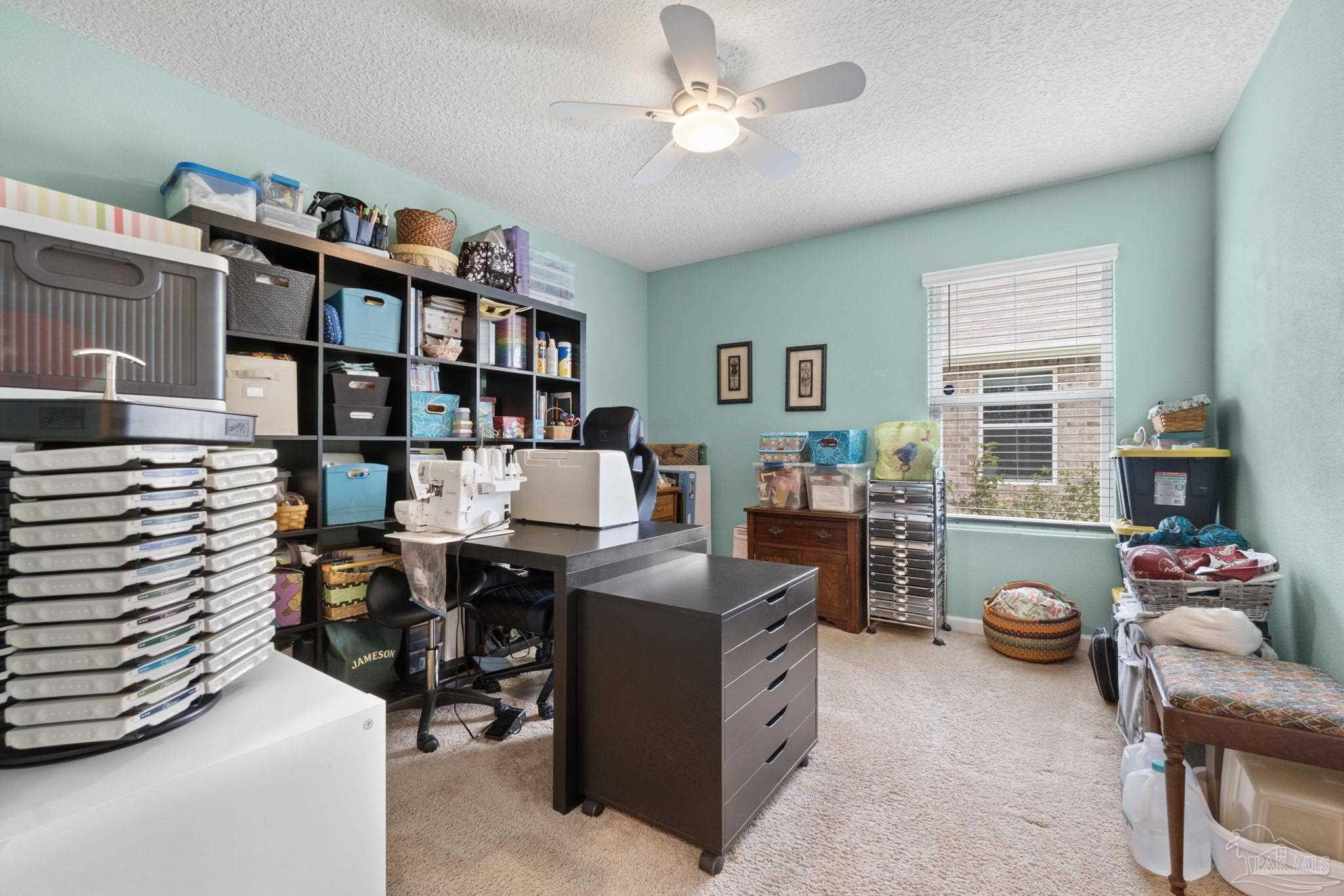 4082 Chickadee Street Milton, FL 32583 - Photo 33 of 43 a work room with furniture and a book shelf