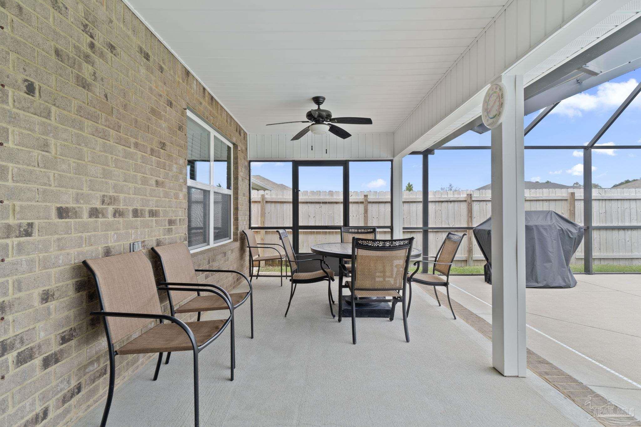 4082 Chickadee Street Milton, FL 32583 - Photo 36 of 43 a dining room with furniture and a floor to ceiling window
