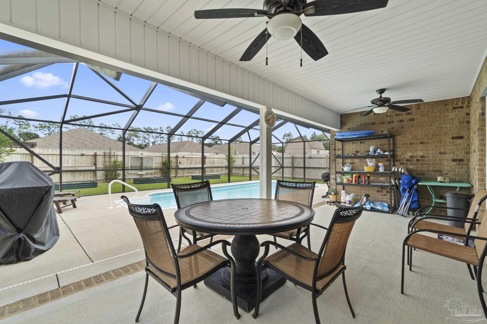4082 Chickadee Street Milton, FL 32583 - Photo 37 of 43 a dining room with furniture and a floor to ceiling window