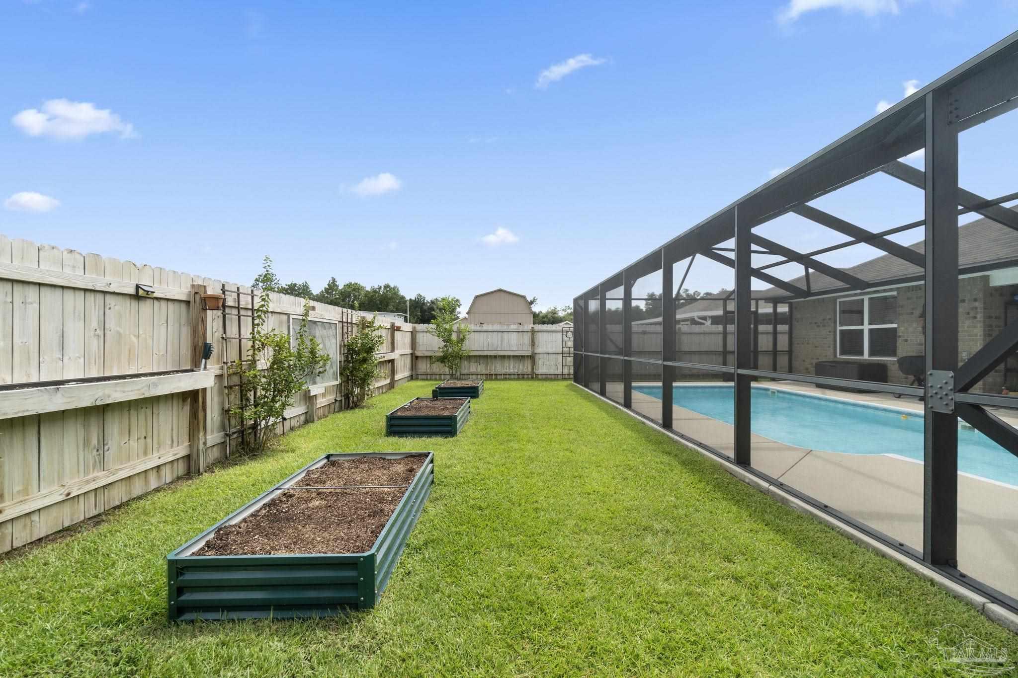 4082 Chickadee Street Milton, FL 32583 - Photo 40 of 43 a view of a backyard with swimming pool