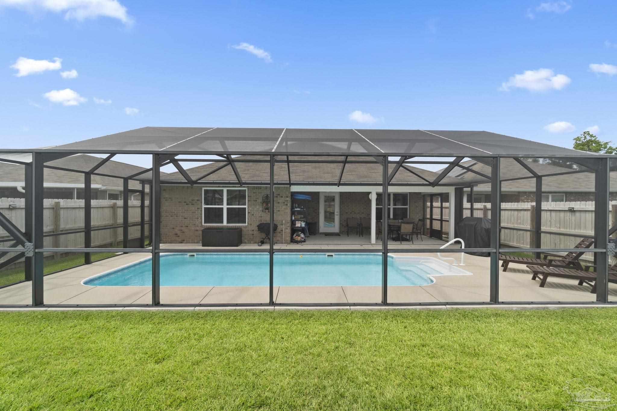 4082 Chickadee Street Milton, FL 32583 - Photo 41 of 43 a view of a house with a backyard and a patio