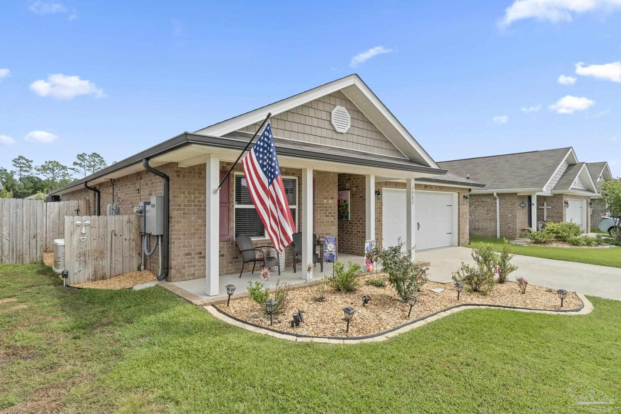 4082 Chickadee Street Milton, FL 32583 - Photo 5 of 43 a backyard of a house with table and chairs