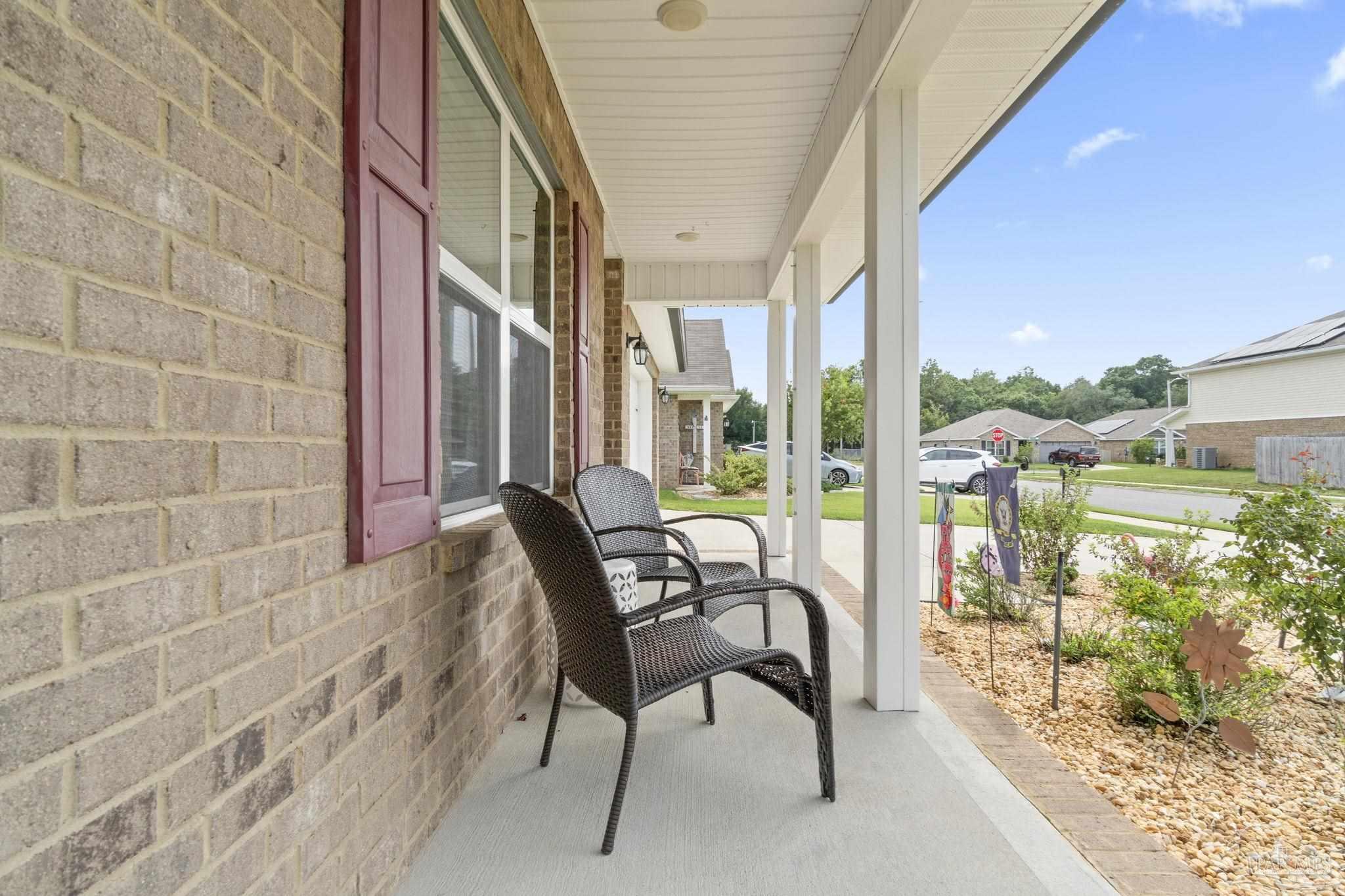 4082 Chickadee Street Milton, FL 32583 - Photo 6 of 43 a balcony with furniture and a potted plant