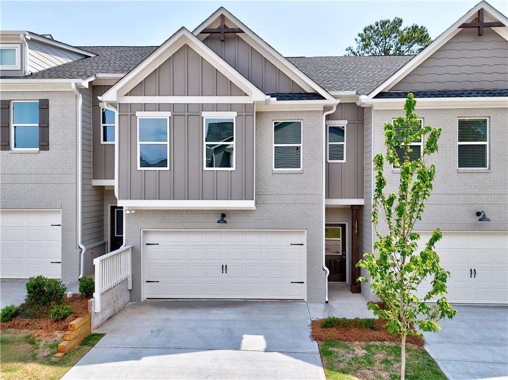 1217 Fern Rdg Lane, Unit 16 Norcross, GA 30093 - Photo 1 of 1 a view of a house with a yard and potted plants