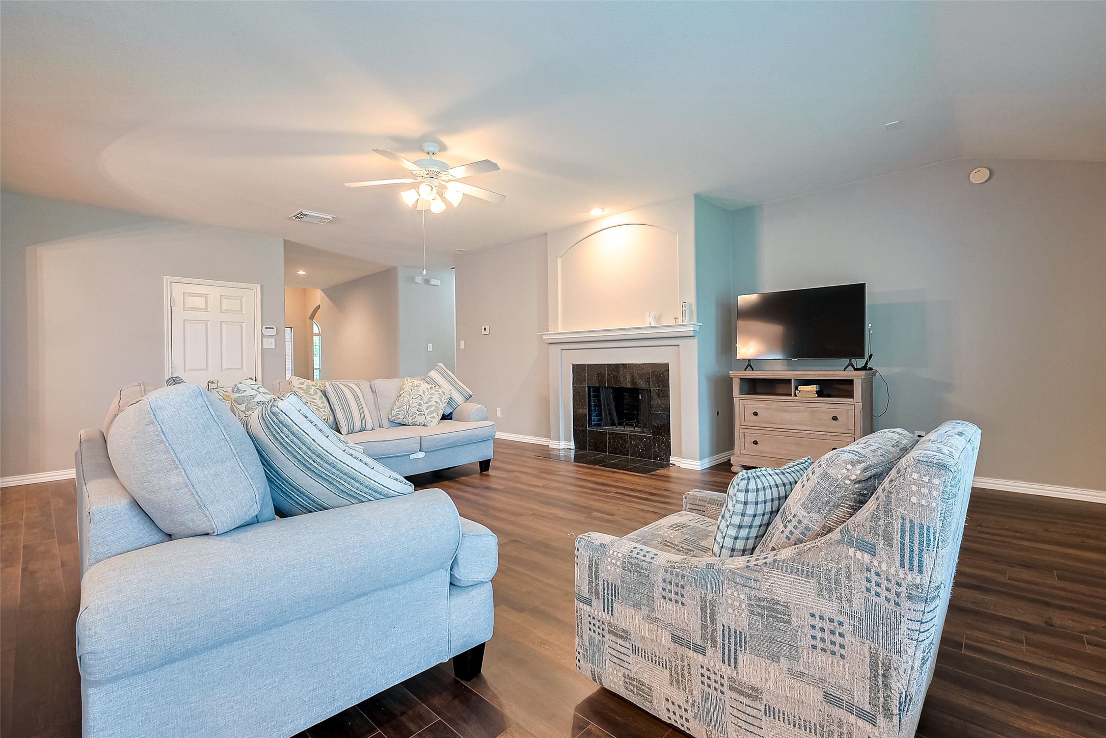 1007 Casting Springs Way Spring, TX 77373 - Photo 14 of 43 a living room with furniture a fireplace and a flat screen tv