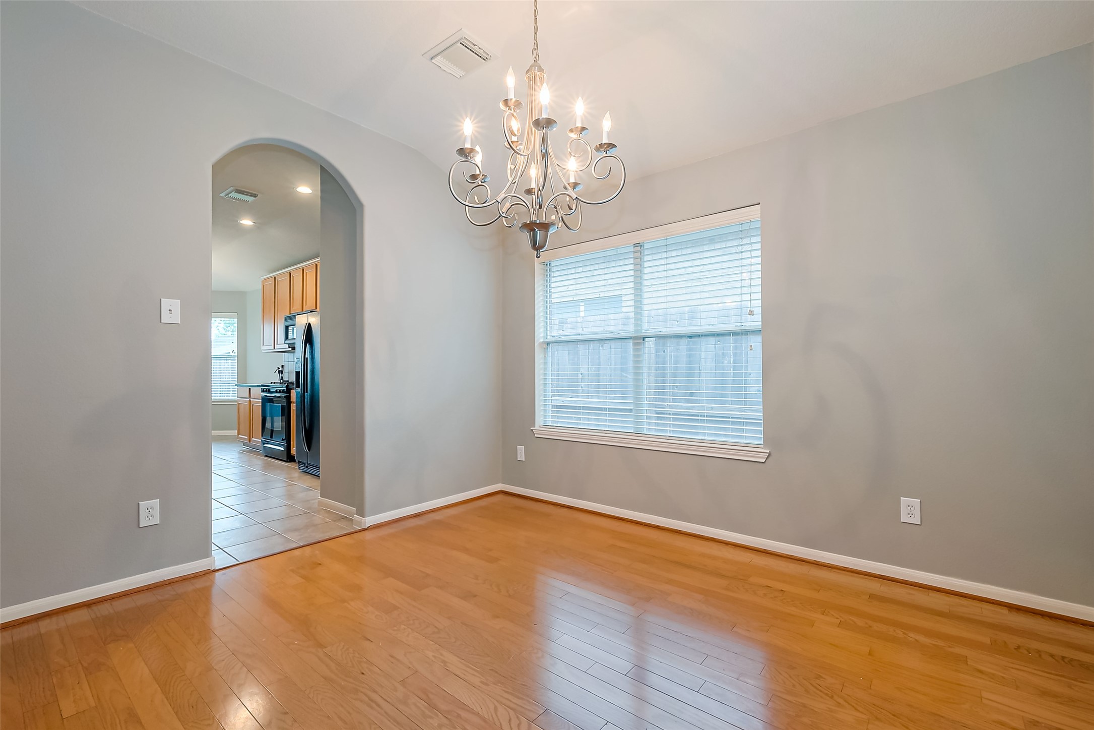 1007 Casting Springs Way Spring, TX 77373 - Photo 16 of 43 wooden floor in an empty room with a window
