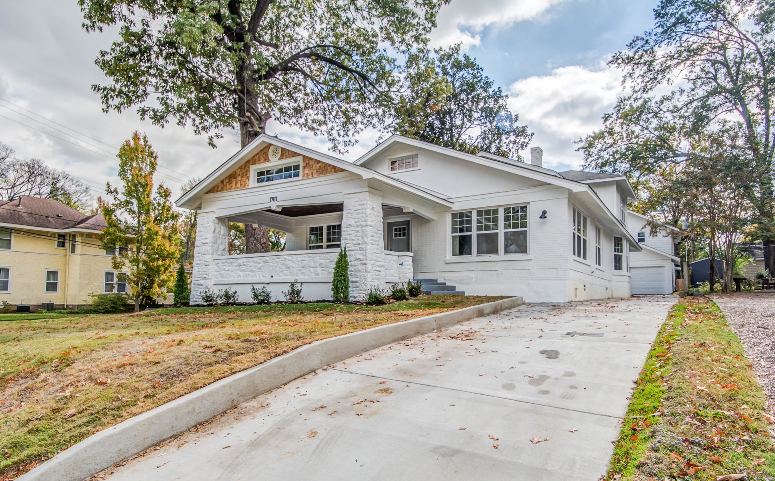 1781 Forest Avenue Memphis, TN 38112 - Photo 1 of 30 View of front of property with a front yard, covered porch, a garage, and driveway
