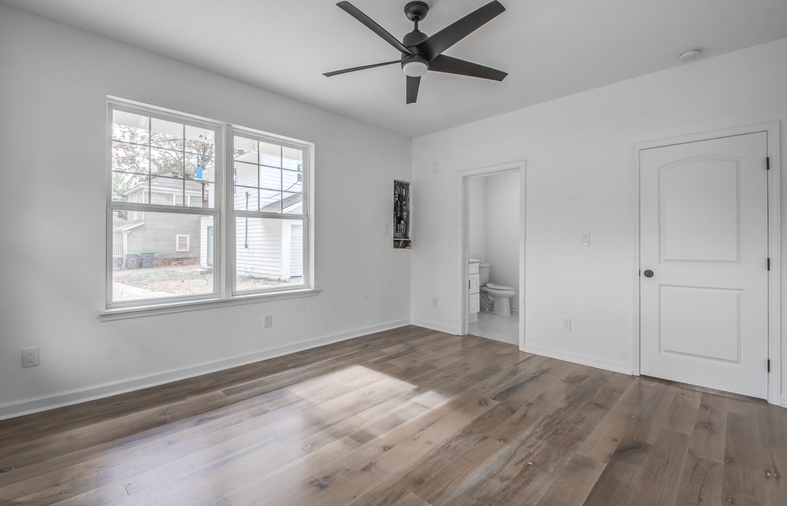 1781 Forest Avenue Memphis, TN 38112 - Photo 22 of 30 Unfurnished bedroom featuring ensuite bathroom, dark wood finished floors, and ceiling fan