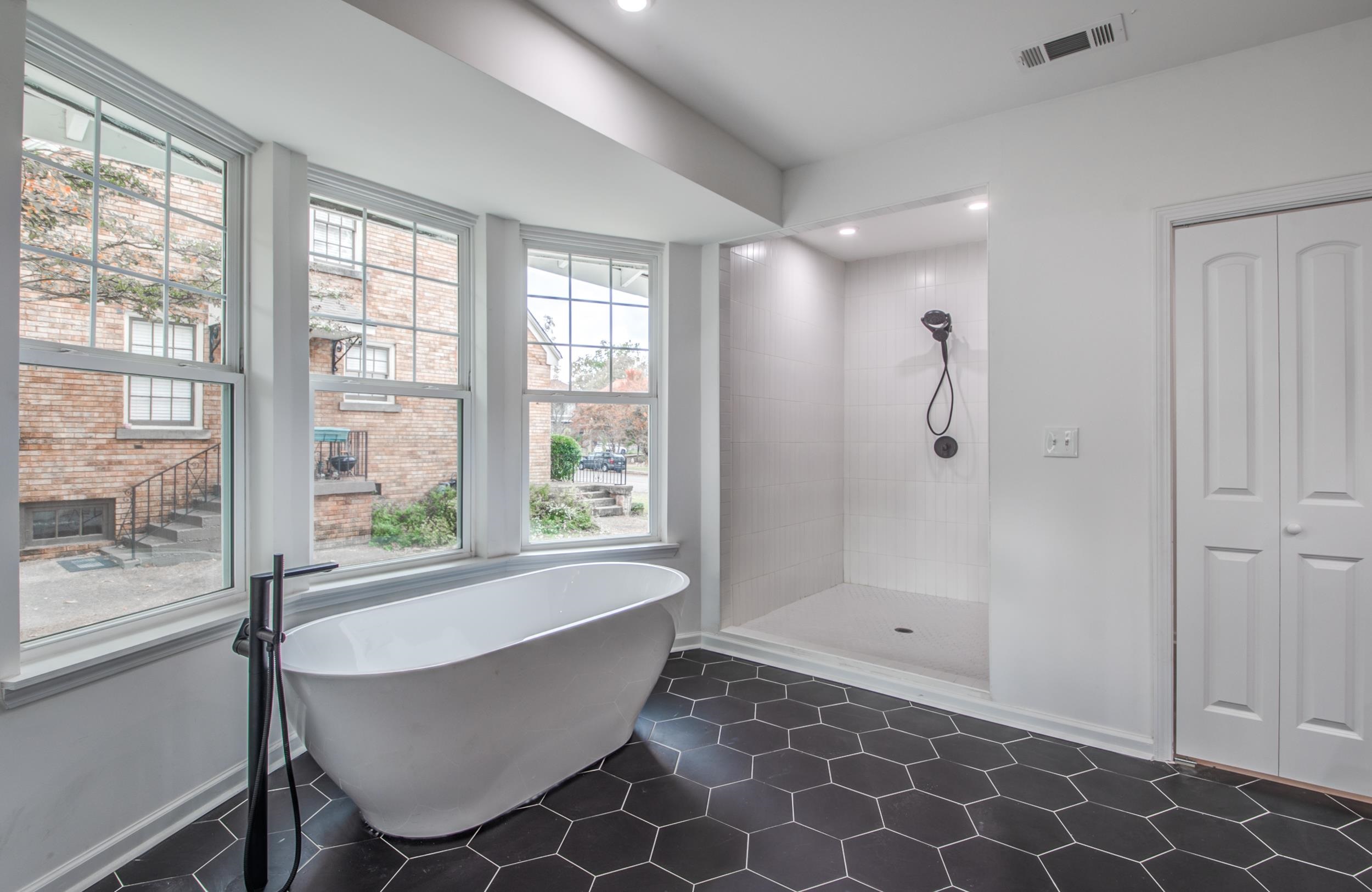 1781 Forest Avenue Memphis, TN 38112 - Photo 27 of 30 Full bath with walk in shower, a soaking tub, recessed lighting, and dark tile patterned flooring