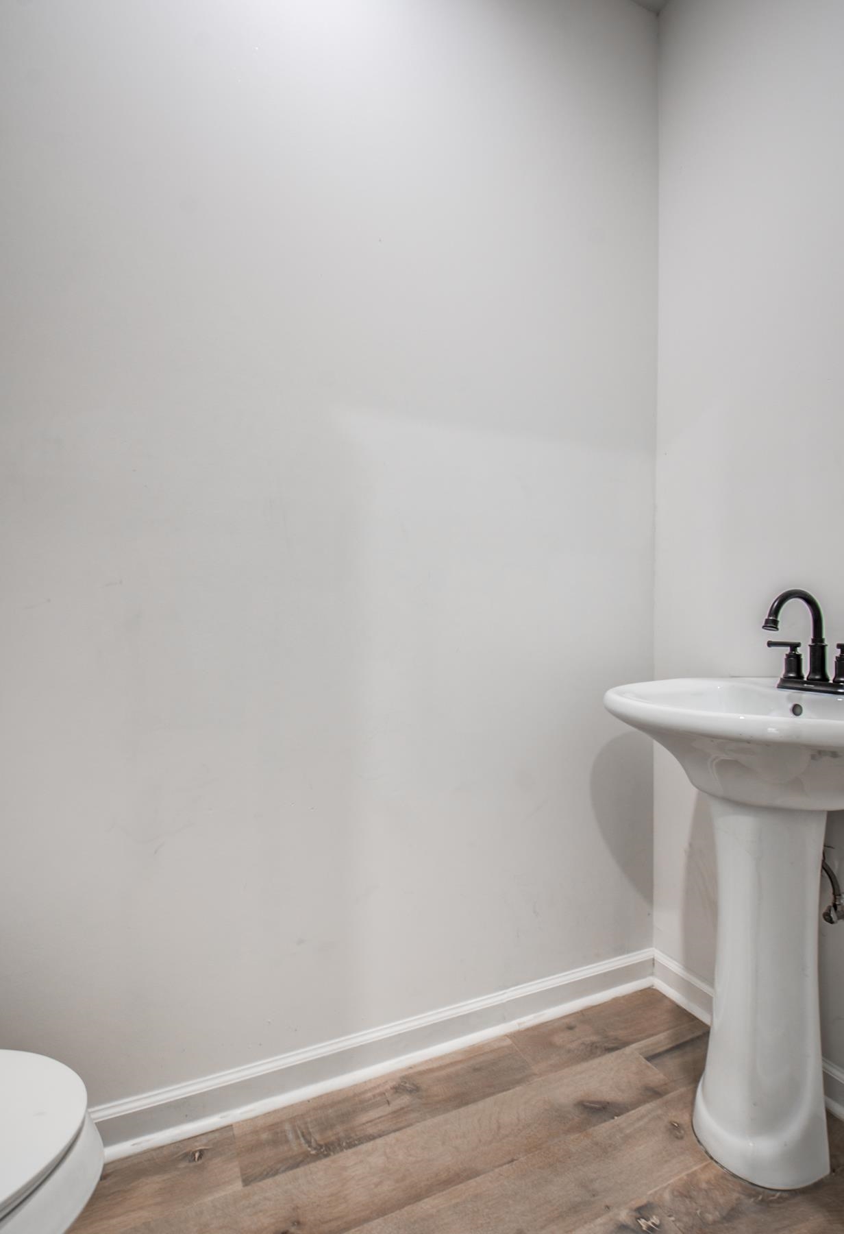 1781 Forest Avenue Memphis, TN 38112 - Photo 28 of 30 Half bath featuring baseboards and wood finished floors