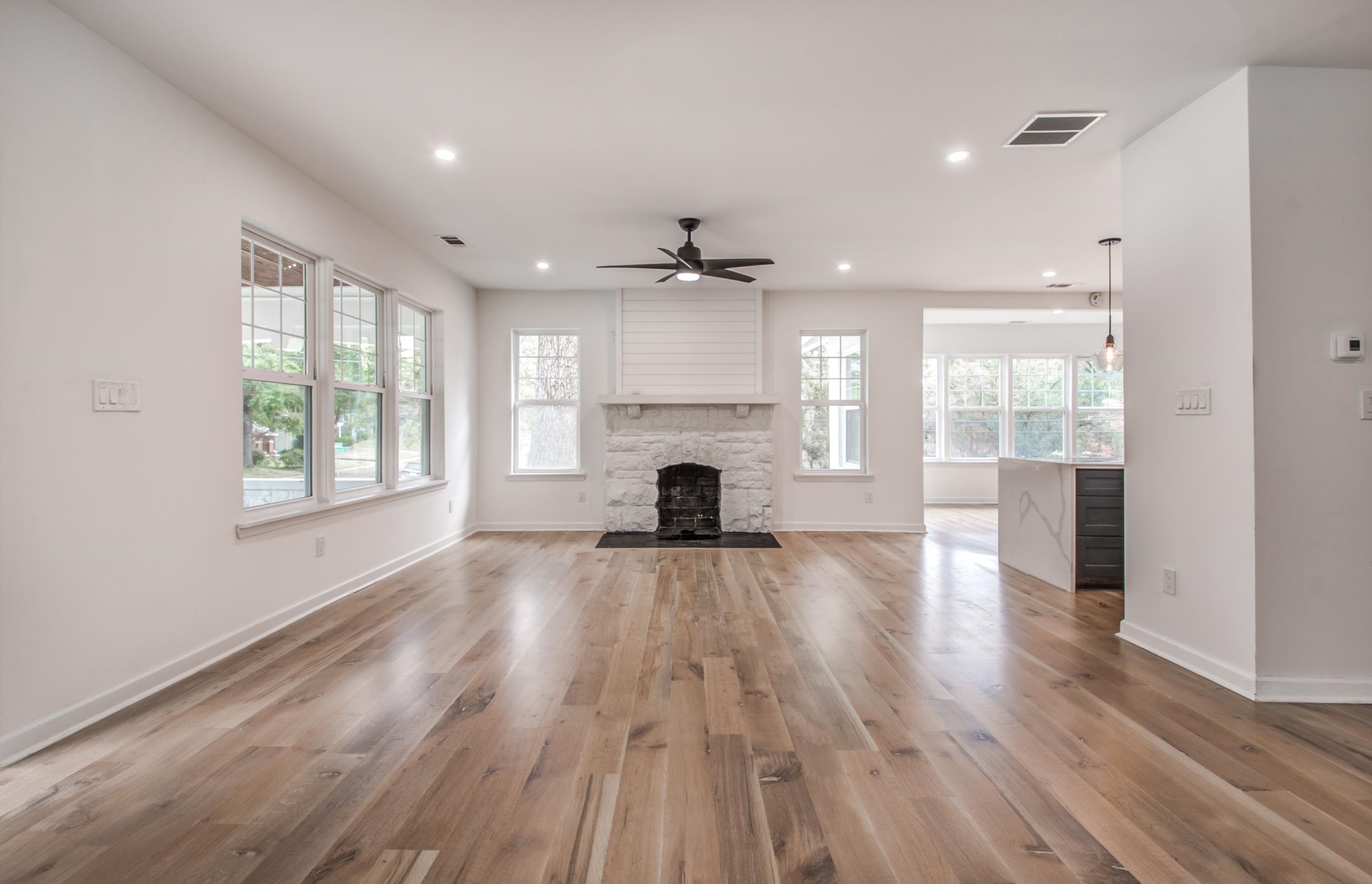 1781 Forest Avenue Memphis, TN 38112 - Photo 5 of 30 Unfurnished living room with a fireplace, light wood-style floors, a ceiling fan, and recessed lighting