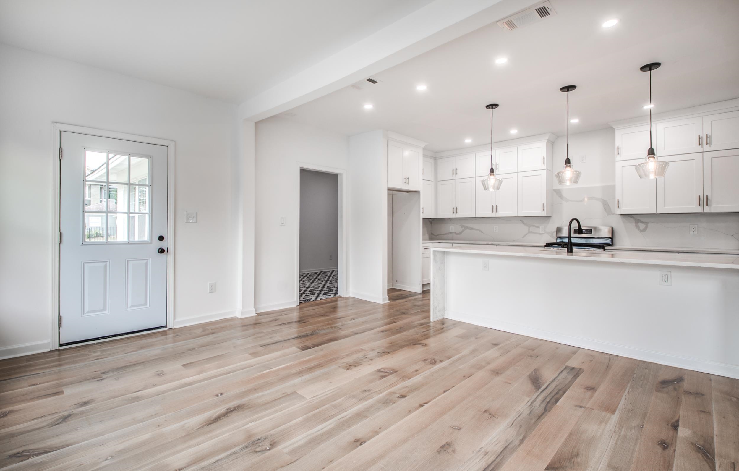 1781 Forest Avenue Memphis, TN 38112 - Photo 29 of 30 Kitchen with white cabinetry, backsplash, decorative light fixtures, open floor plan, and recessed lighting