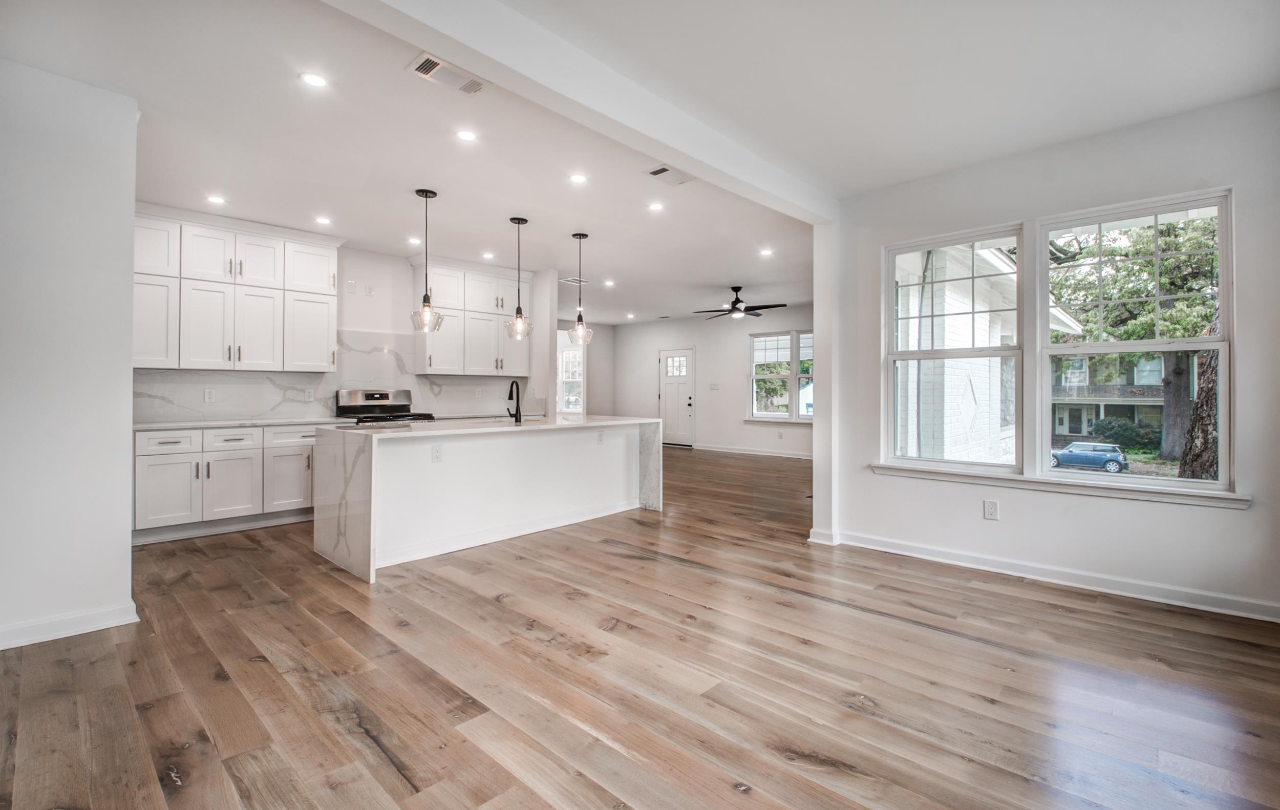 1781 Forest Avenue Memphis, TN 38112 - Photo 30 of 30 Kitchen with open floor plan, an island with sink, white cabinetry, recessed lighting, and decorative light fixtures