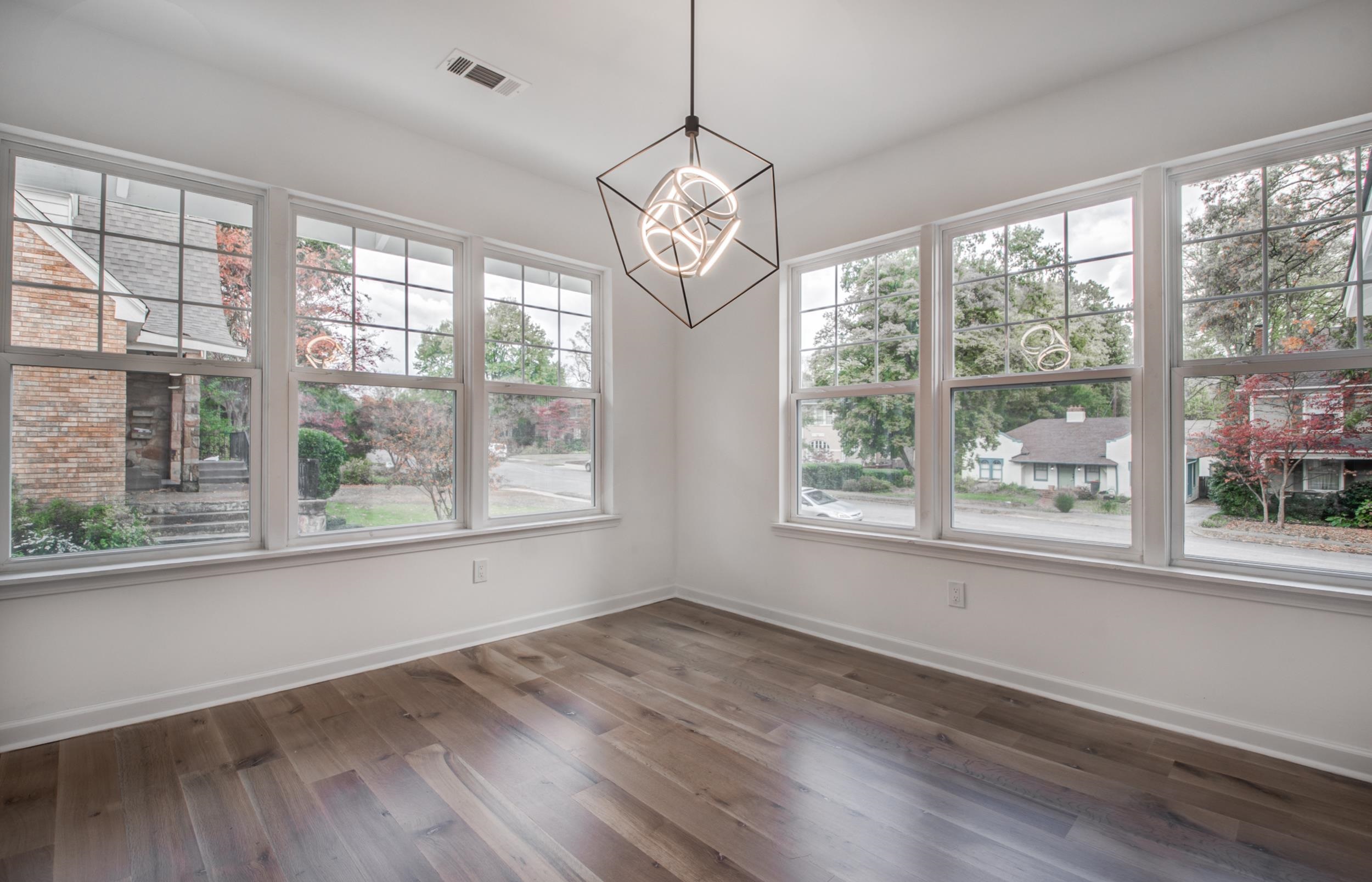 1781 Forest Avenue Memphis, TN 38112 - Photo 8 of 30 Unfurnished dining area with hardwood / wood-style floors, a chandelier, and healthy amount of natural light