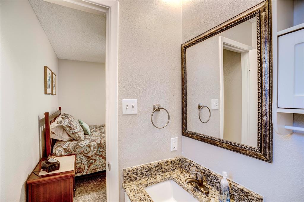 6028 Ridgecrest Drive Watauga, TX 76148 - Photo 21 of 40 a bathroom with a sink and a mirror