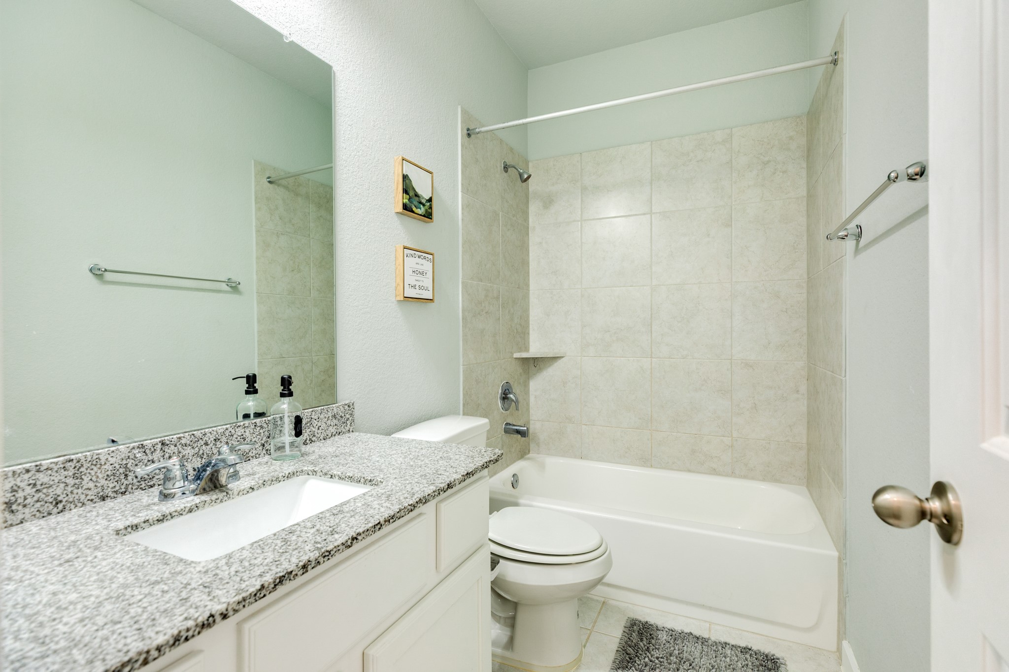 4015 Shackleton Court Iowa Colony, TX 77583 - Photo 26 of 50 Secondary bathroom featuring a tub/shower combination, elegant quartz countertops, and durable tile flooring; this functional space is conveniently shared between the two secondary bedrooms.
