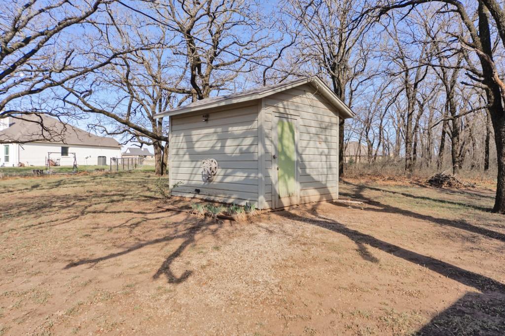449 Olde Towne Road Paradise, TX 76073 - Photo 16 of 23 a backyard of a house with large trees and outdoor seating