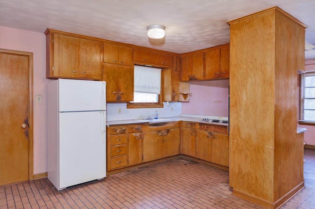 449 Olde Towne Road Paradise, TX 76073 - Photo 19 of 23 a kitchen with granite countertop a refrigerator a sink and dishwasher a refrigerator with wooden cabinets