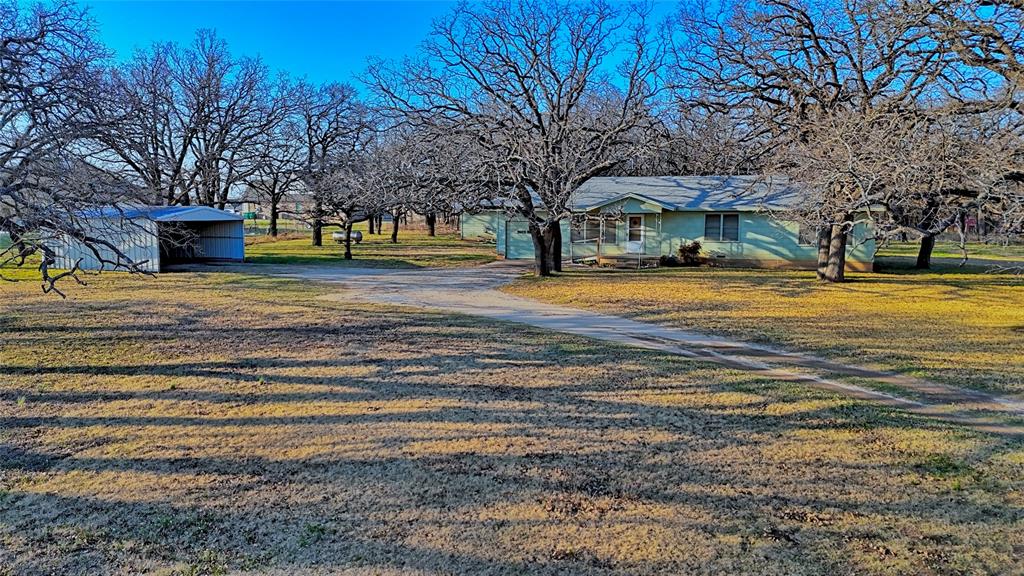 449 Olde Towne Road Paradise, TX 76073 - Photo 4 of 23 a view of a house with a yard and large trees