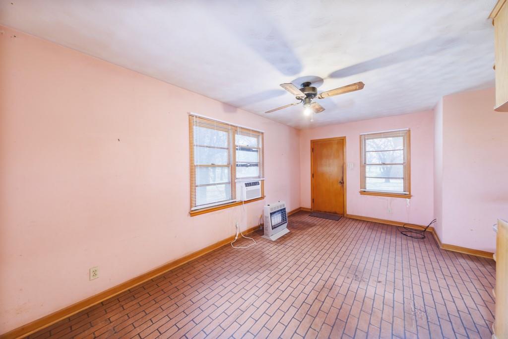 449 Olde Towne Road Paradise, TX 76073 - Photo 8 of 23 an empty room with wooden floor and windows