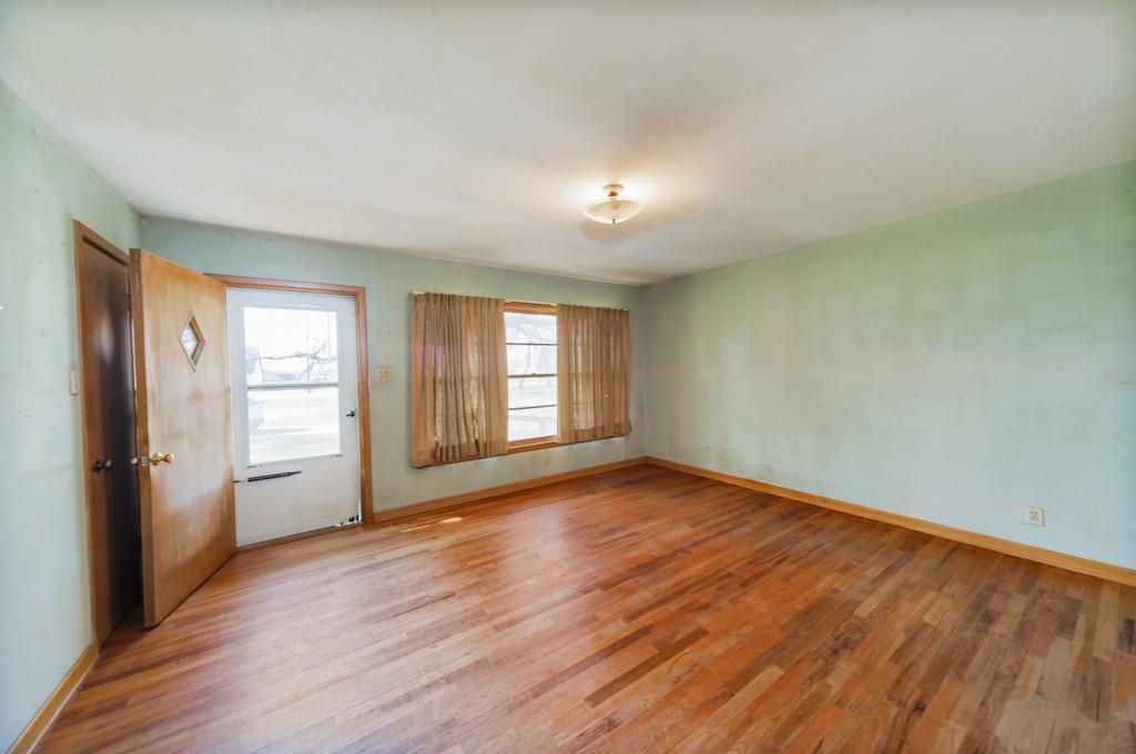 449 Olde Towne Road Paradise, TX 76073 - Photo 9 of 23 an empty room with wooden floor and windows