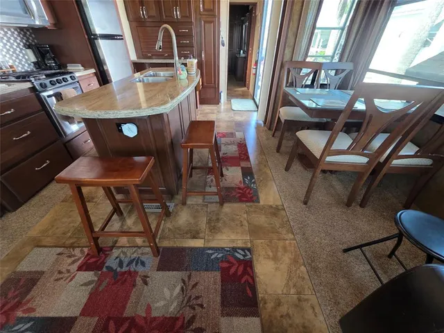 a kitchen with stainless steel appliances granite countertop a refrigerator and a stove