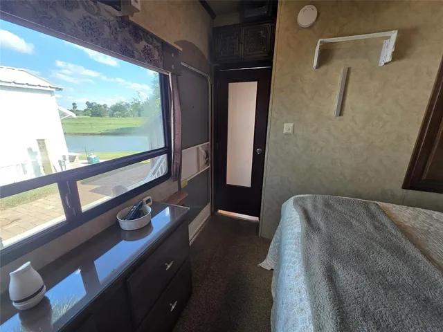 a bathroom with a granite countertop toilet sink and mirror