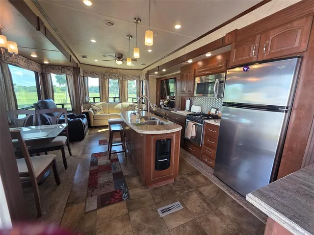 a kitchen with a stove a sink and a microwave