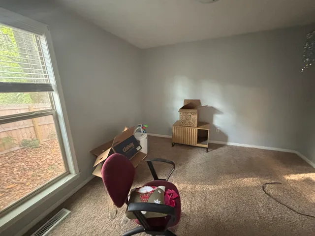 a view of a house with a tree and a yard