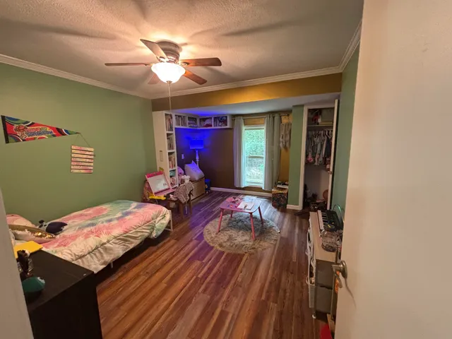 a bedroom with furniture and a wooden floor