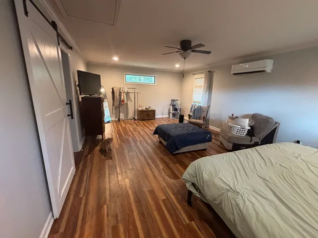 a bedroom with furniture and a chandelier