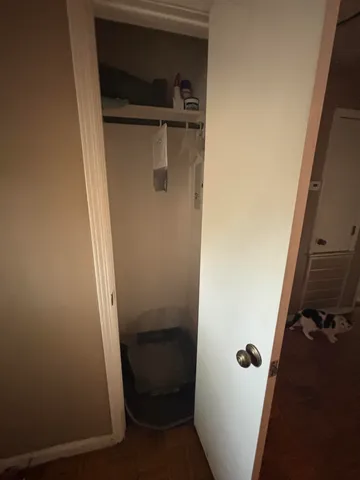 a bed room with furniture and a air conditioner vent