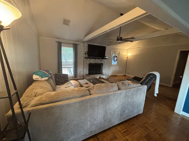 a living room with furniture fireplace and flat screen tv