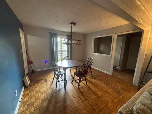 a dining room with furniture window and wooden floor
