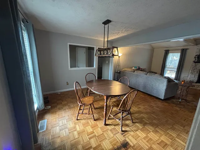a dining room with furniture and window