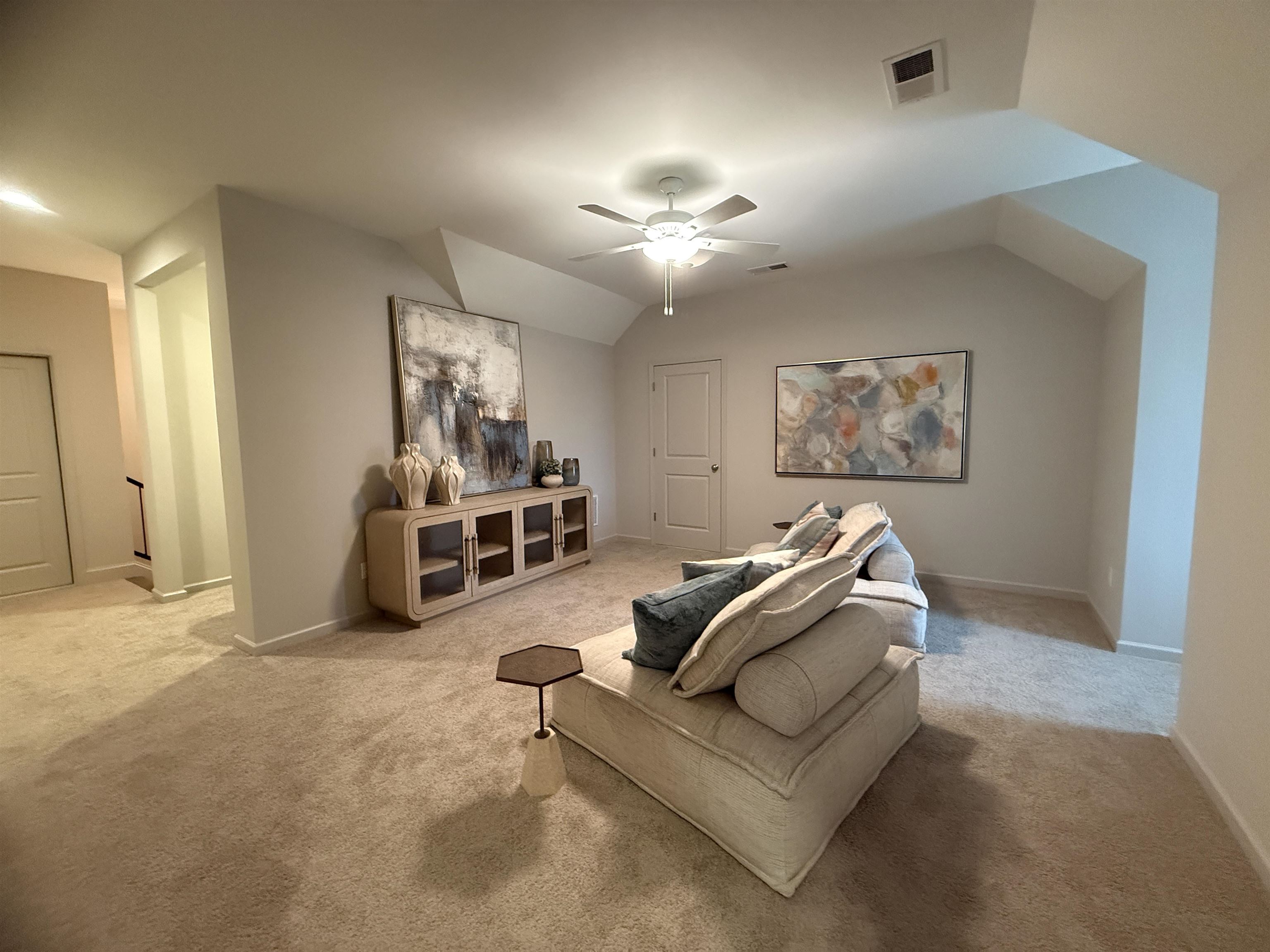 11516 Sunsparkler Way Collierville, TN 38017 - Photo 14 of 24 Carpeted living area with vaulted ceiling and a ceiling fan