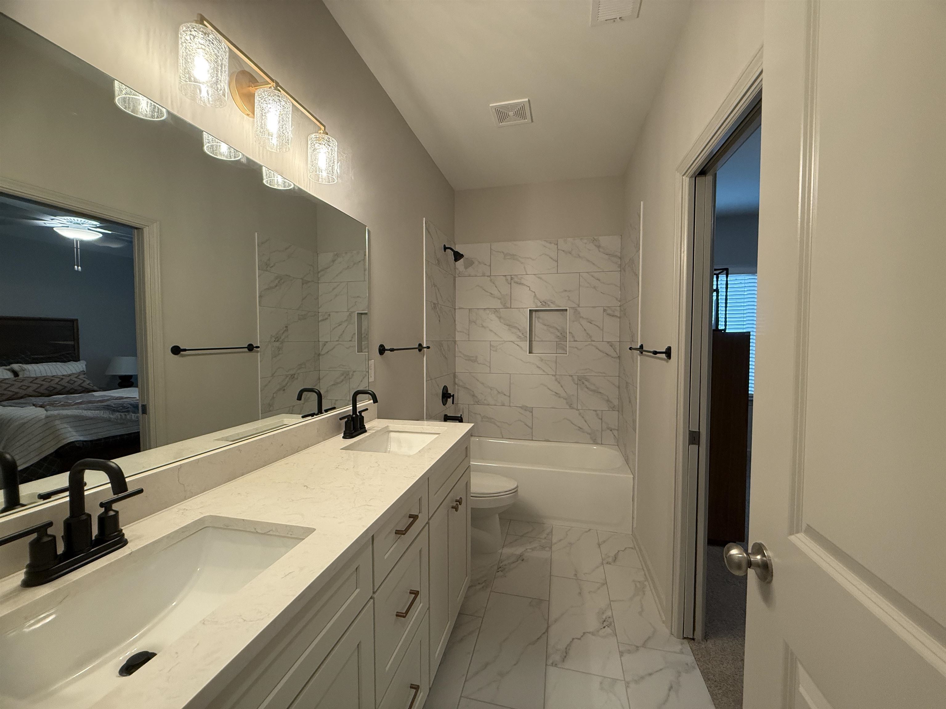 11516 Sunsparkler Way Collierville, TN 38017 - Photo 16 of 24 Ensuite bathroom with double vanity, shower combination, and light marble finish floors