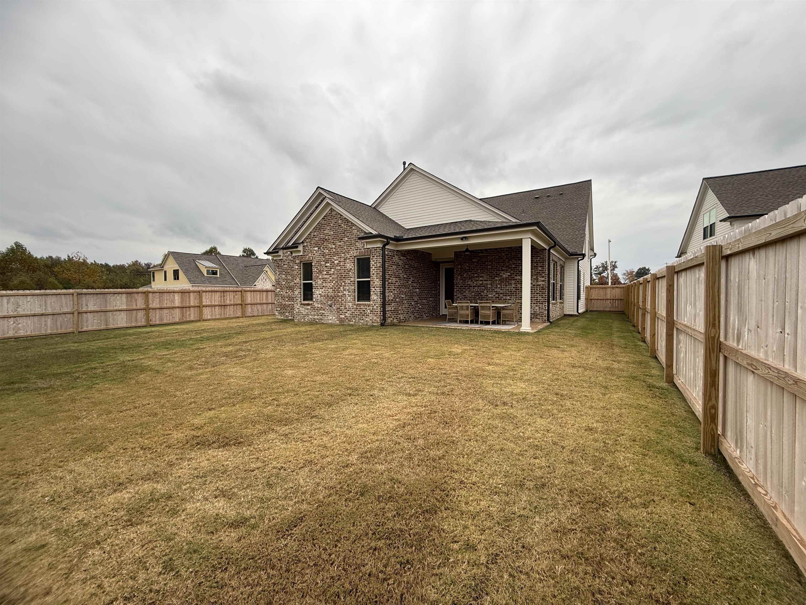 11516 Sunsparkler Way Collierville, TN 38017 - Photo 20 of 24 Back of house with a fenced backyard, a patio area, brick siding, and roof with shingles