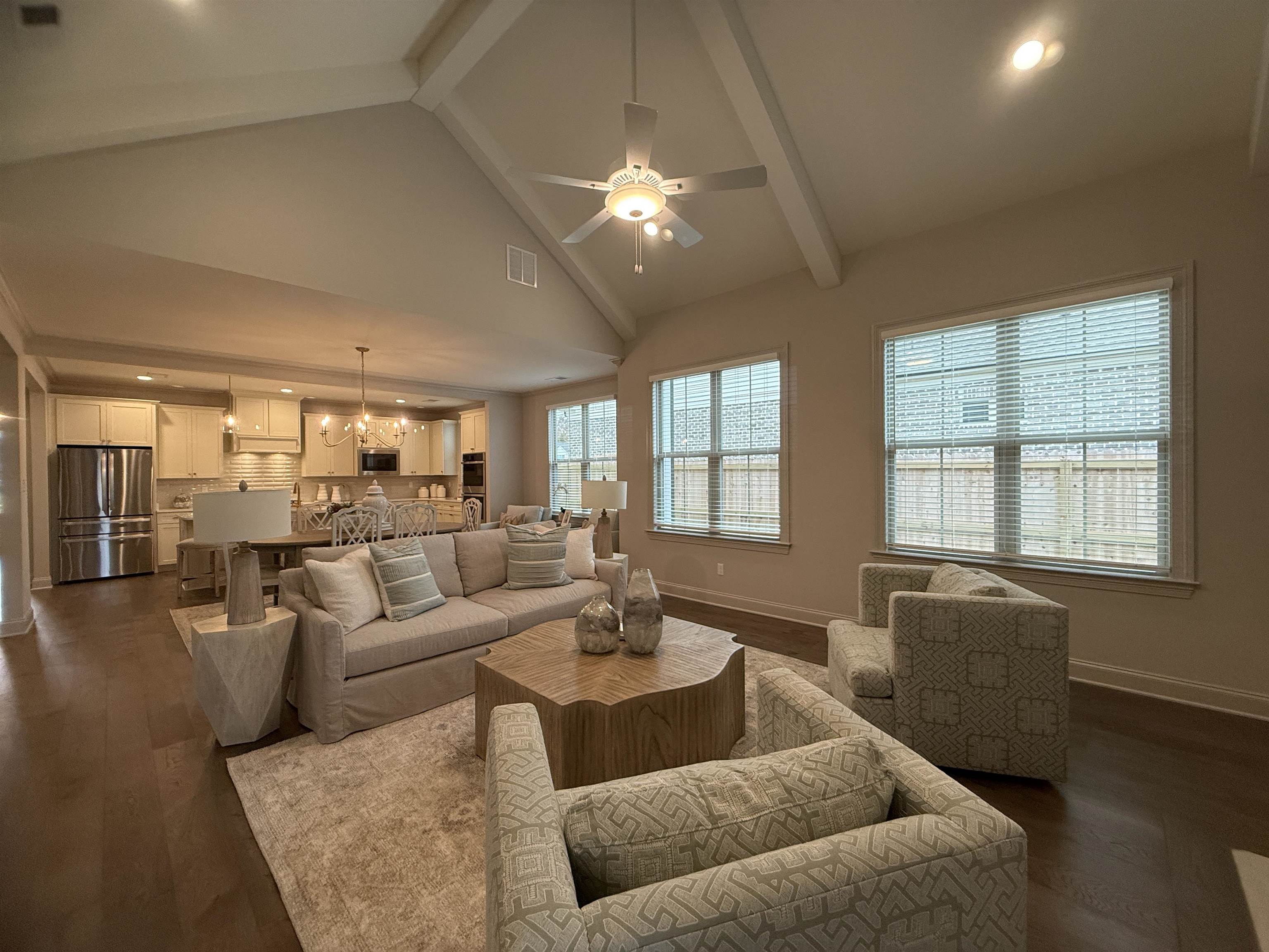 11516 Sunsparkler Way Collierville, TN 38017 - Photo 5 of 24 Living room featuring high vaulted ceiling, beamed ceiling, a ceiling fan, a chandelier, and dark wood-type flooring